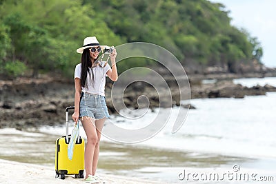 Happy traveler and tourism young women travel summer on the beach.Â  Stock Photo